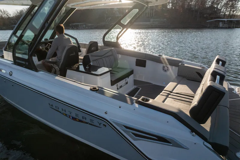  Yacht Photos Pics 2026 Monterey Elite 30 OB boat on a serene lake at sunset.
