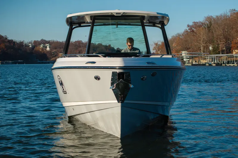  Yacht Photos Pics 2026 Monterey Elite 30 OB boat on a serene lake with autumn trees.