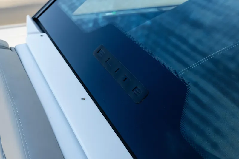  Yacht Photos Pics Close-up of 2026 Monterey Elite 30 OB boat windshield with "Elite" branding.