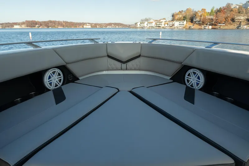  Yacht Photos Pics Luxurious seating on 2026 Monterey Elite 30 OB boat, with scenic lake view.
