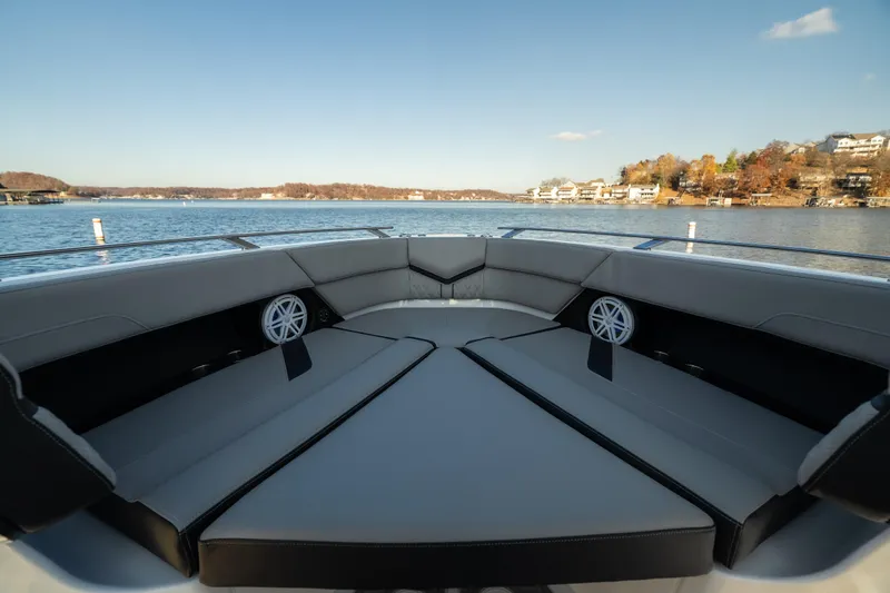  Yacht Photos Pics Luxurious seating on 2026 Monterey Elite 30 OB boat with scenic lake view.