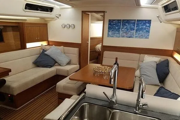 "jocale Ii" Yacht Photos Pics Interior of 2016 Hanse 455 yacht with cozy seating, dining table, and modern decor.