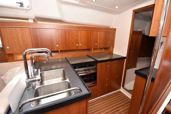 "jocale Ii" Yacht Photos Pics Modern kitchen in 2016 Hanse 455 yacht with wood cabinetry and dual sink.