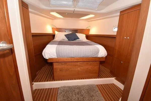 "jocale Ii" Yacht Photos Pics Luxurious cabin interior of 2016 Hanse 455 yacht with cozy bed and wooden finish.