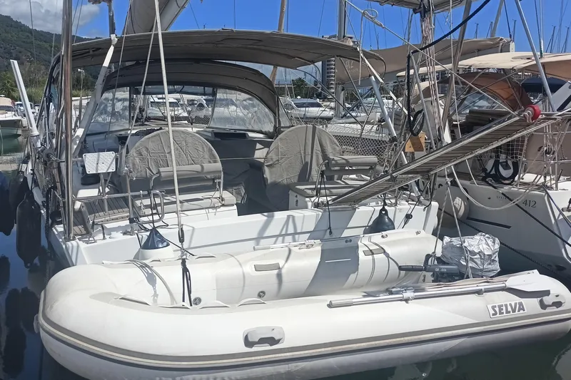 "jocale Ii" Yacht Photos Pics Sailboat Hanse 455 (2016) docked with inflatable dinghy, marina background.