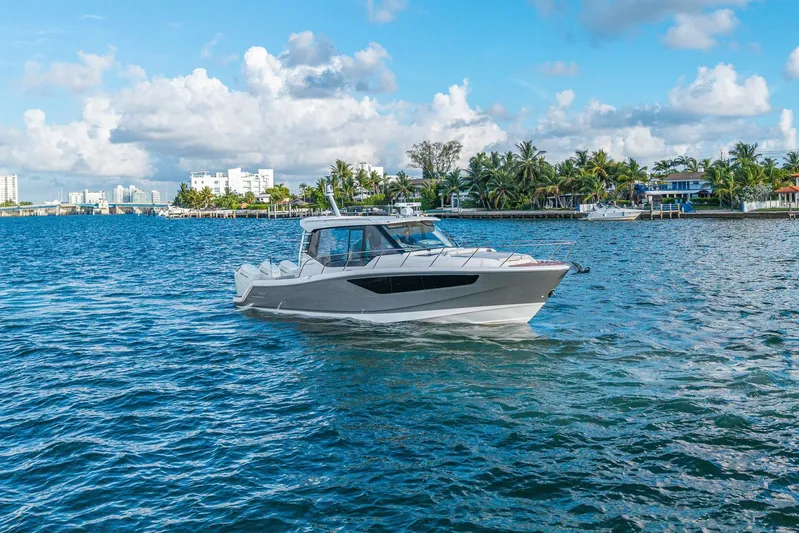  Yacht Photos Pics 2024 Boston Whaler 405 Conquest cruising on a scenic, tropical waterway.