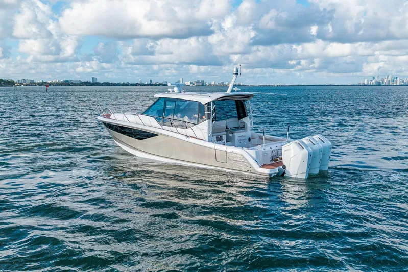  Yacht Photos Pics 2024 Boston Whaler 405 Conquest boat cruising on open water under a cloudy sky.