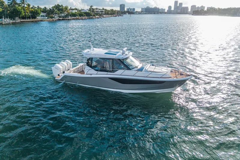  Yacht Photos Pics 2024 Boston Whaler 405 Conquest cruising on a sunny day in coastal waters.