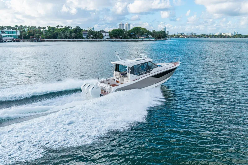  Yacht Photos Pics 2024 Boston Whaler 405 Conquest cruising on open water, showcasing sleek design and powerful engines.
