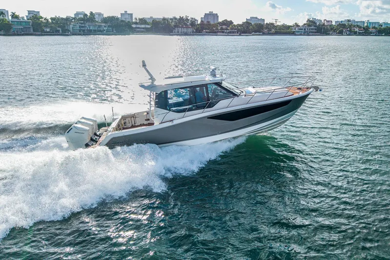  Yacht Photos Pics 2024 Boston Whaler 405 Conquest cruising on a sunny day in coastal waters.