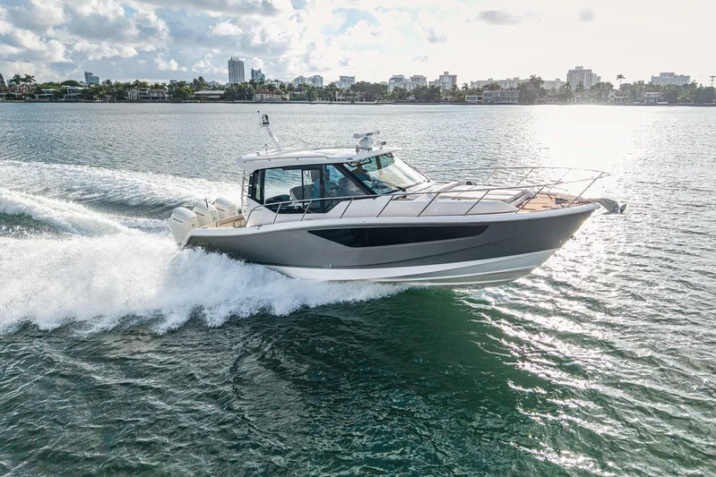  Yacht Photos Pics 2024 Boston Whaler 405 Conquest cruising on a sunny day, showcasing sleek design and performance.