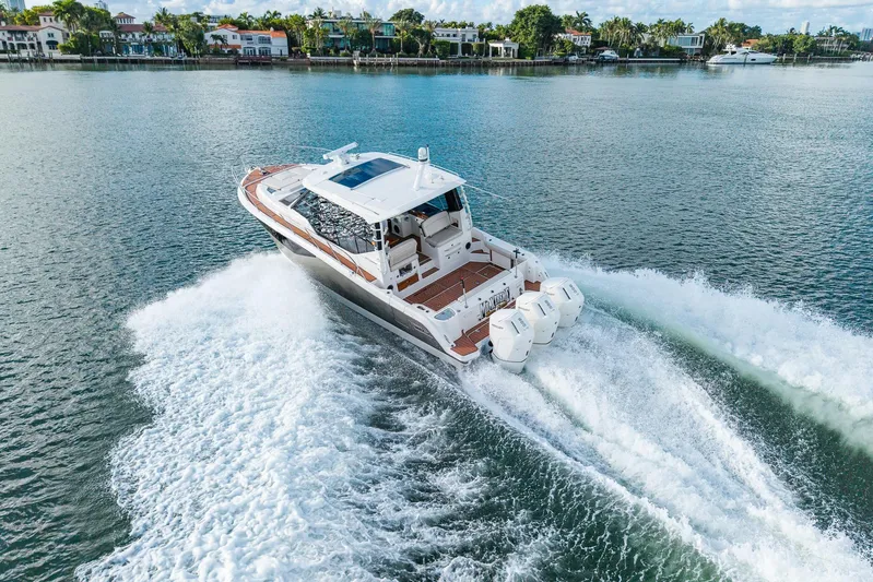  Yacht Photos Pics 2024 Boston Whaler 405 Conquest cruising on a scenic waterway, showcasing powerful engines.