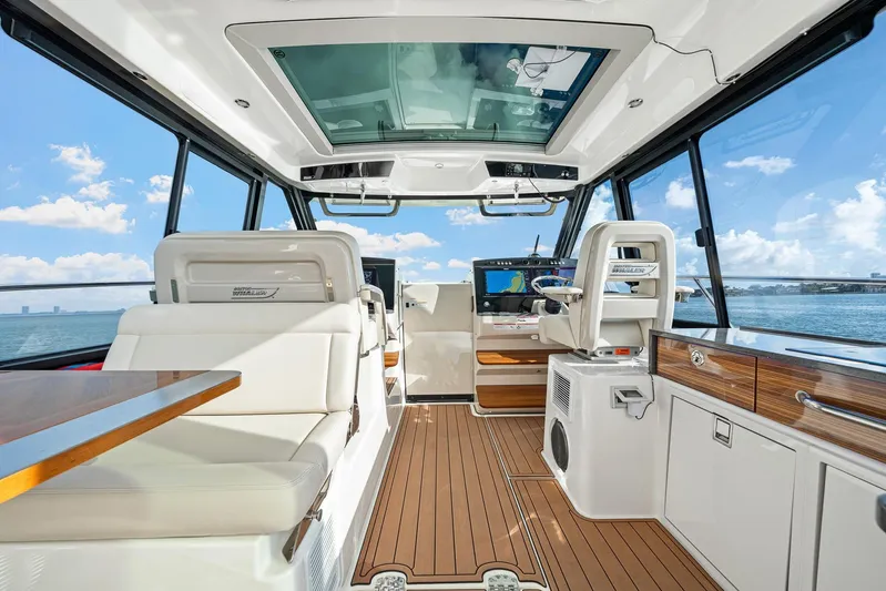  Yacht Photos Pics Luxurious interior of 2024 Boston Whaler 405 Conquest boat with modern navigation equipment.