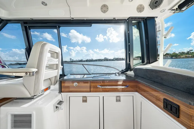  Yacht Photos Pics 2024 Boston Whaler 405 Conquest interior with scenic water view through windows.