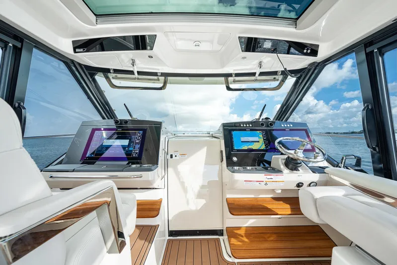  Yacht Photos Pics 2024 Boston Whaler 405 Conquest helm with advanced navigation displays and luxurious seating.