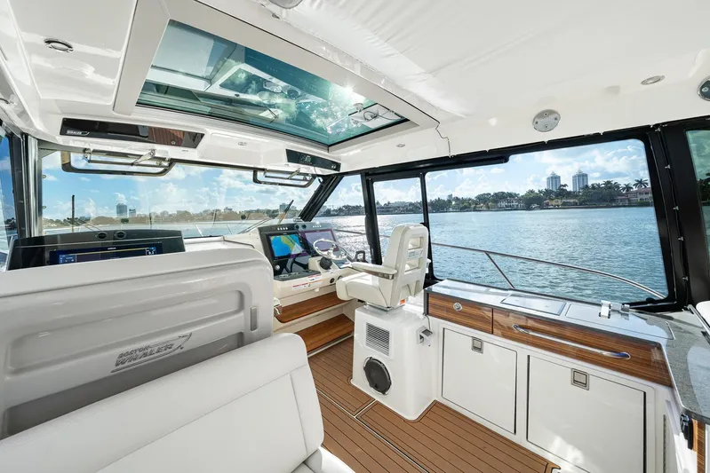  Yacht Photos Pics 2024 Boston Whaler 405 Conquest interior with modern helm and panoramic water views.