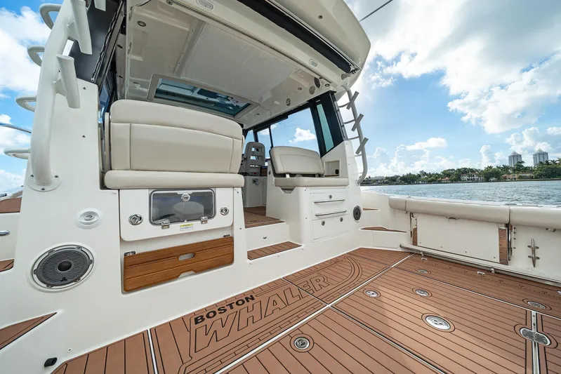  Yacht Photos Pics 2024 Boston Whaler 405 Conquest boat interior with seating and deck view.