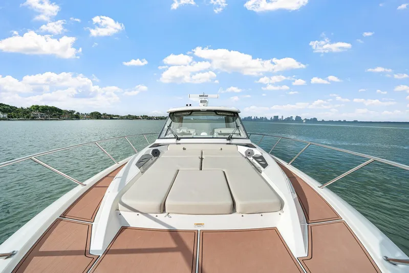  Yacht Photos Pics 2024 Boston Whaler 405 Conquest boat on calm water under blue sky.