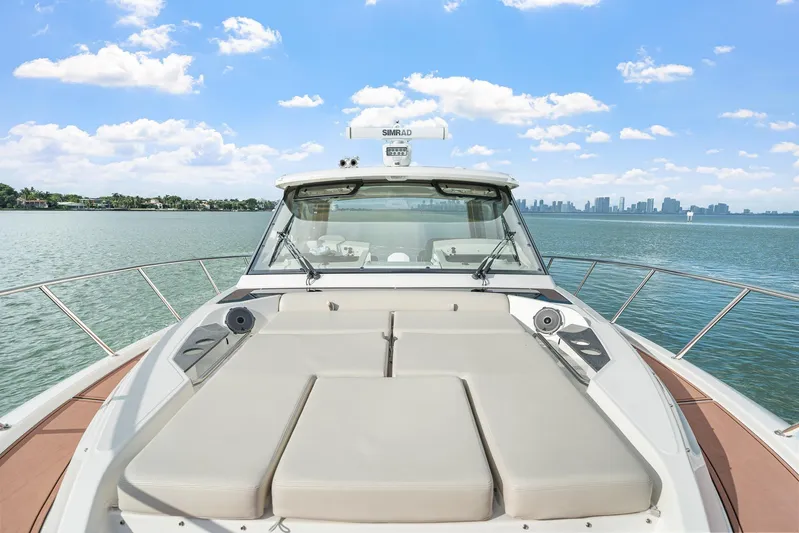 Yacht Photos Pics 2024 Boston Whaler 405 Conquest boat on water with city skyline background.