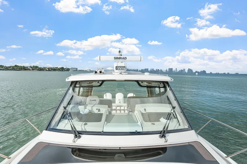  Yacht Photos Pics 2024 Boston Whaler 405 Conquest on water with city skyline in background.