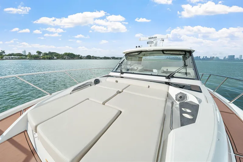  Yacht Photos Pics 2024 Boston Whaler 405 Conquest yacht on calm waters under a clear sky.