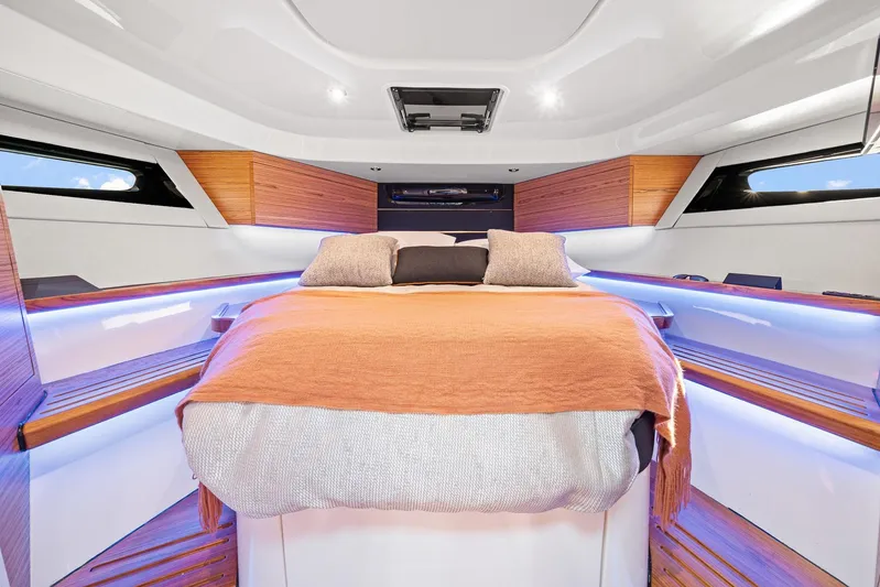  Yacht Photos Pics Luxurious cabin interior of 2024 Boston Whaler 405 Conquest with cozy bedding.