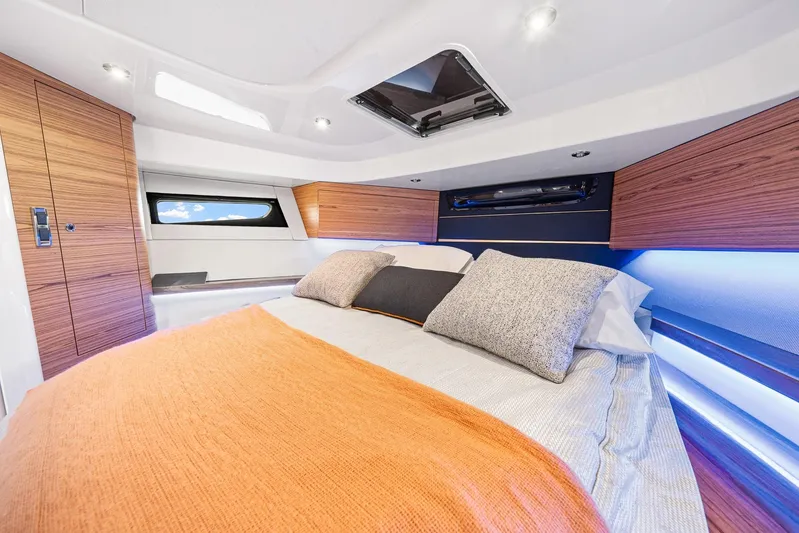  Yacht Photos Pics Luxurious cabin interior of 2024 Boston Whaler 405 Conquest with modern bedding and wood accents.