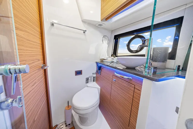 Yacht Photos Pics Luxurious bathroom in 2024 Boston Whaler 405 Conquest yacht with modern fixtures and ocean view.
