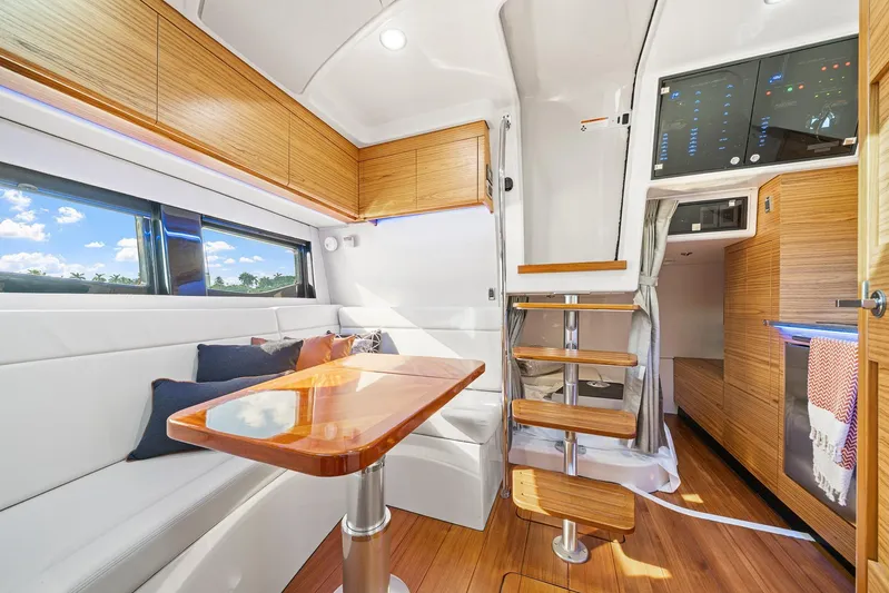  Yacht Photos Pics Luxurious interior of 2024 Boston Whaler 405 Conquest yacht with modern wood finishes.