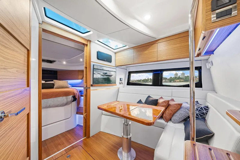  Yacht Photos Pics Luxurious interior of 2024 Boston Whaler 405 Conquest yacht with modern seating and wood accents.