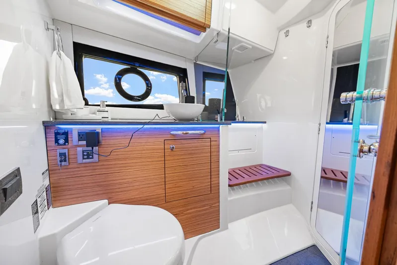  Yacht Photos Pics Luxurious bathroom interior of 2024 Boston Whaler 405 Conquest yacht with modern amenities.