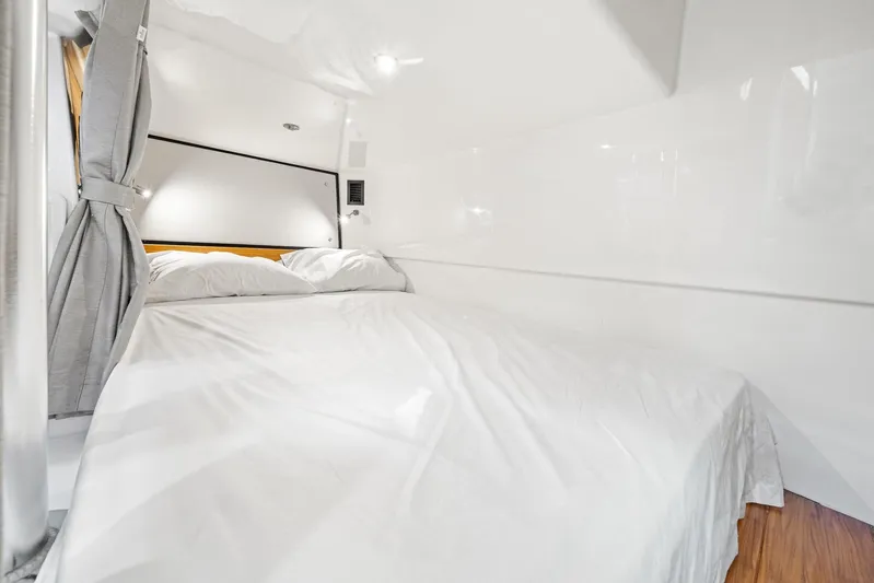  Yacht Photos Pics Luxurious cabin interior of 2024 Boston Whaler 405 Conquest with cozy bedding.