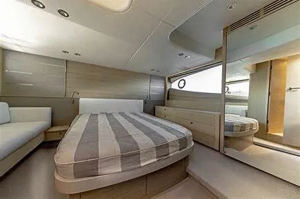 Yacht Photos Pics Luxurious bedroom interior of 2019 Princess V50 yacht with modern design and striped bedding.