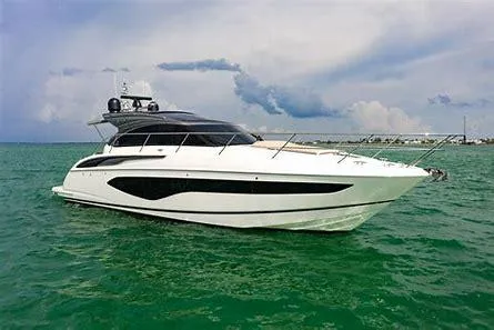  Yacht Photos Pics 2019 Princess V50 yacht cruising on calm green waters under a cloudy sky.