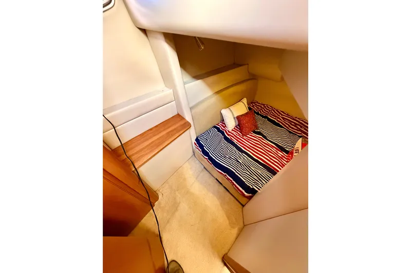 Yacht Photos Pics 2003 Meridian 341 Sedan cabin interior with striped bedding and cozy decor.