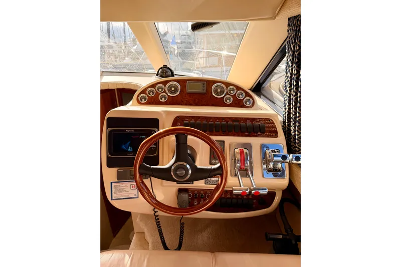  Yacht Photos Pics 2003 Meridian 341 Sedan helm with wood accents and modern controls.