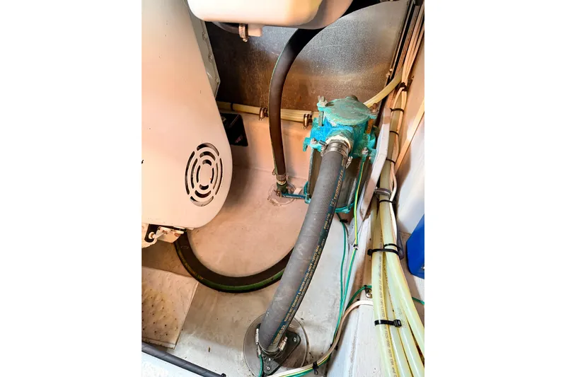  Yacht Photos Pics Engine room of 2003 Meridian 341 Sedan with visible hoses and machinery.