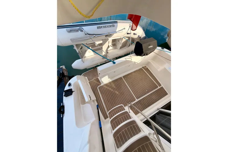  Yacht Photos Pics 2003 Meridian 341 Sedan yacht deck with inflatable boat and wooden flooring.