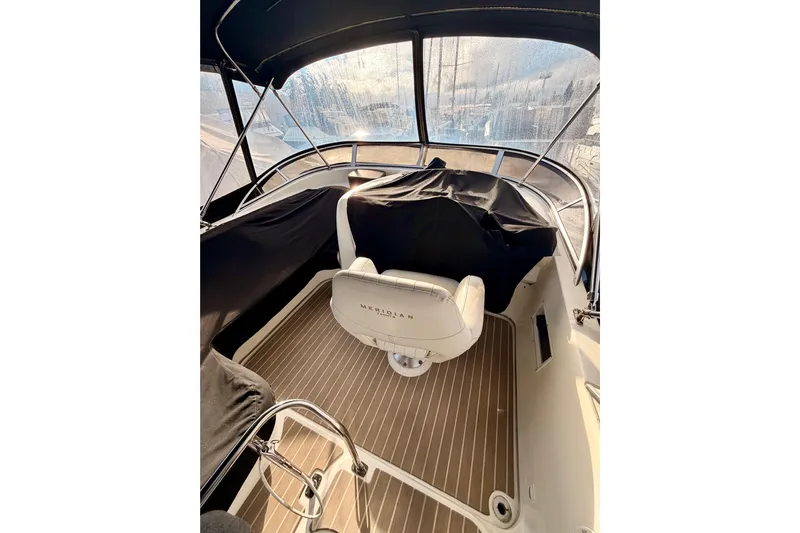  Yacht Photos Pics Interior view of 2003 Meridian 341 Sedan boat with helm and seating area.