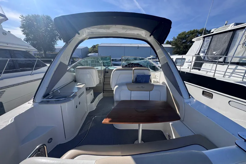  Yacht Photos Pics 2008 Sea Ray 350 Sundancer interior with seating and table, docked among other boats.