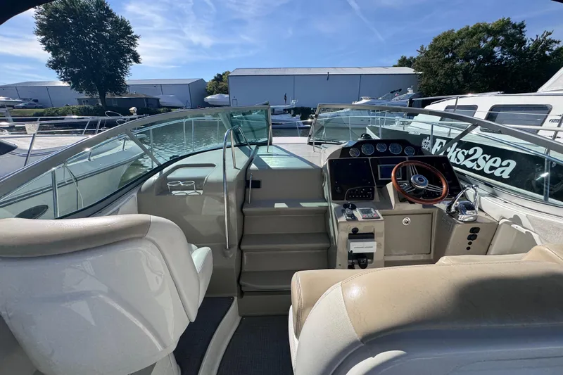  Yacht Photos Pics 2008 Sea Ray 350 Sundancer cockpit with steering wheel and control panel, docked under clear sky.