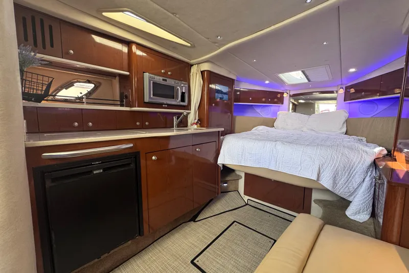  Yacht Photos Pics Luxurious interior of 2008 Sea Ray 350 Sundancer yacht with bed, kitchenette, and ambient lighting.