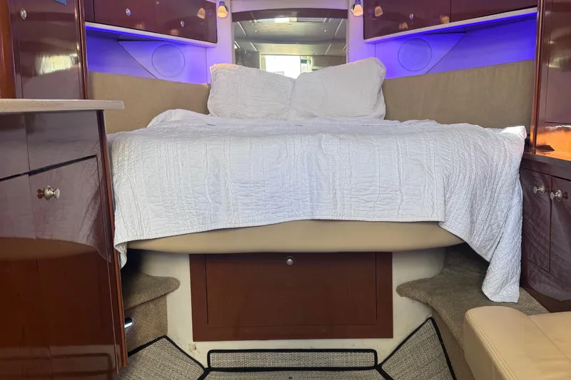  Yacht Photos Pics Luxurious cabin interior of 2008 Sea Ray 350 Sundancer with cozy bed and ambient lighting.