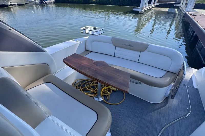  Yacht Photos Pics 2008 Sea Ray 350 Sundancer boat interior with seating and wooden table, docked by the water.