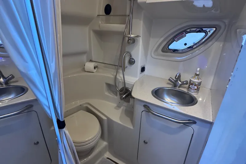 Yacht Photos Pics 2008 Sea Ray 350 Sundancer bathroom with shower, sink, and porthole window.