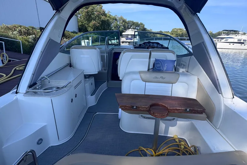  Yacht Photos Pics 2008 Sea Ray 350 Sundancer interior with seating, table, and kitchenette by the water.