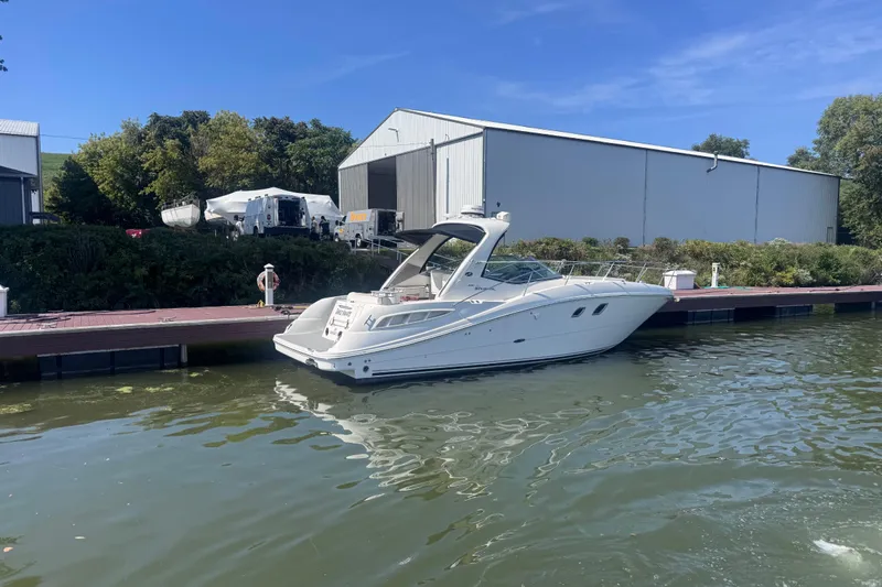  Yacht Photos Pics 2008 Sea Ray 350 Sundancer yacht docked by a marina under clear blue skies.