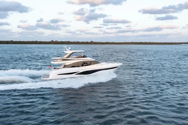  Yacht Photos Pics 2026 Princess F65 yacht cruising on open water under a partly cloudy sky.