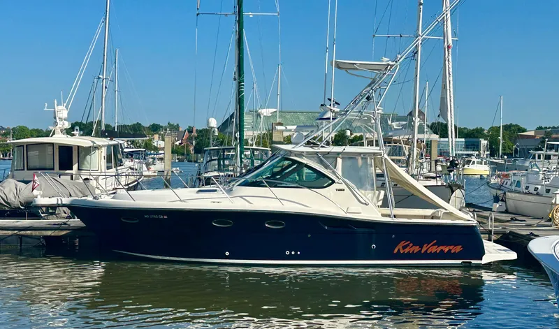  Yacht Photos Pics 2004 Tiara Yachts 3200 Open docked in a marina, surrounded by other boats.
