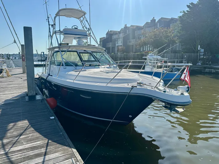  Yacht Photos Pics 2004 Tiara Yachts 3200 Open docked at marina, sunny day, waterfront buildings in background.